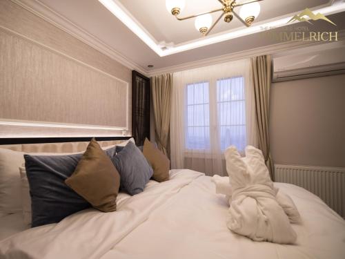 a large white bed in a room with a window at Boutique Hotel Himmelrich in Lucerne