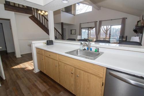 a kitchen with a sink and a large mirror at Margarita Manor on Staniel Cay in Osage Beach