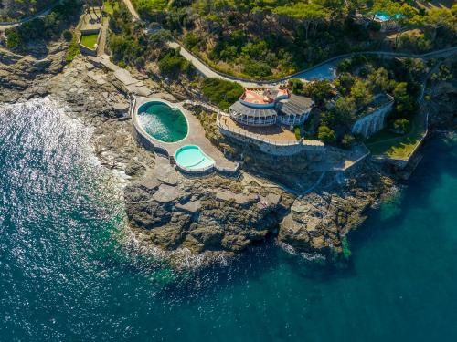 an aerial view of a house on a cliff next to the water at Marina Elite Capo D'Arco in Capo D'Arco