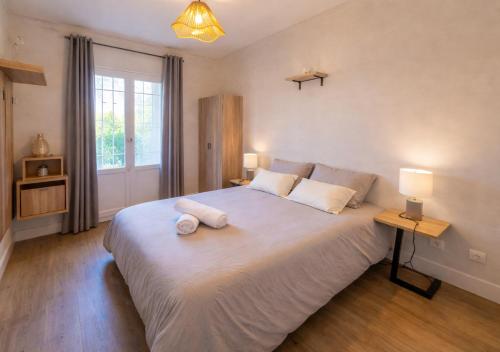 a bedroom with a large bed with two pillows on it at Hôtel restaurant ANGEL'S in Angles