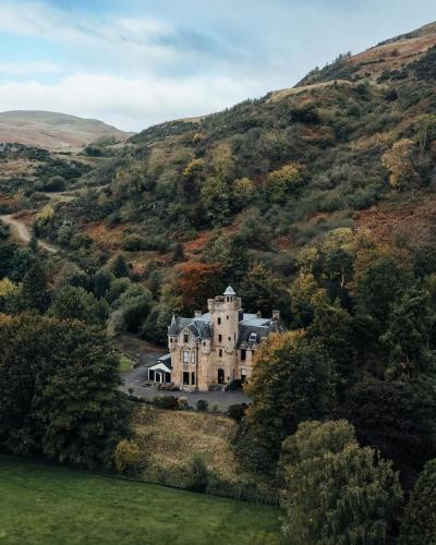 an old house in the middle of a hill at Broomhall Castle Hotel in Stirling