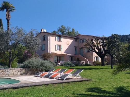 a large house with a pool in front of it at L'Escale Provençale in Tourrettes