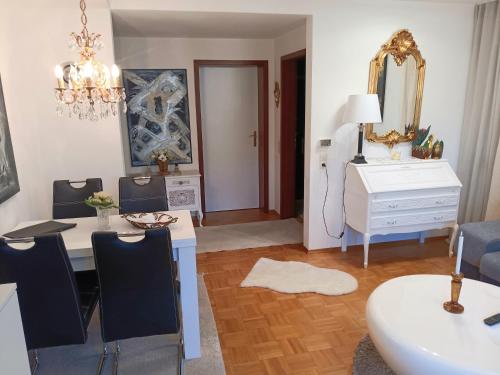 a living room with a white table and a mirror at La Suite in Baden-Baden
