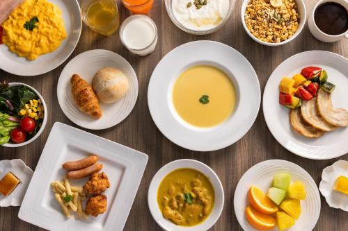 a table topped with plates of food and bowls of food at Hotel Keihan Tsukiji Ginza Grande in Tokyo