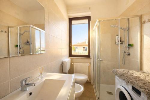 a bathroom with a sink and a toilet and a shower at LaBohème Lake Maggiore Retreat with Private Beach in Dormelletto