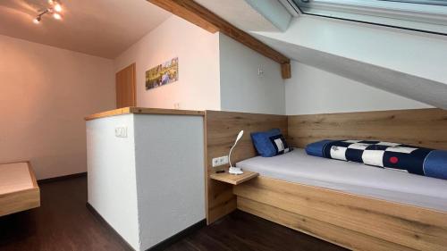 a small room with a bed in a loft at Apfel-Stadl "Gala", Oberreute in Oberreute