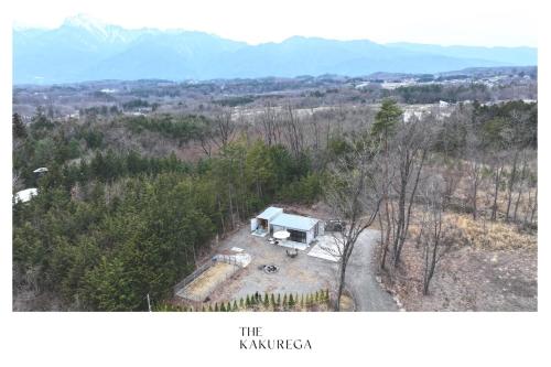 an aerial view of a white camper in the woods at The KAKUREGA in Hokuto