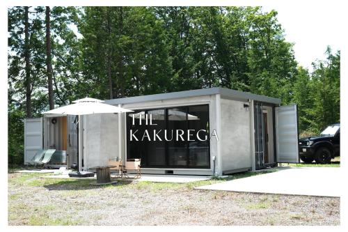 a trailer with a sign that reads the kkarma at The KAKUREGA in Hokuto