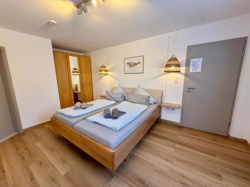 a bedroom with a large bed with blue sheets at Strandbude Borkum in Borkum