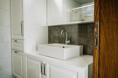 a white sink in a white kitchen with at Mistral Alaçatı Hotel in Çeşme