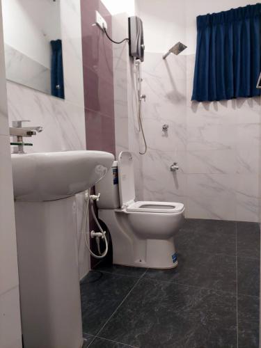 a bathroom with a toilet and a sink at Skyline Residence in Wadduwa