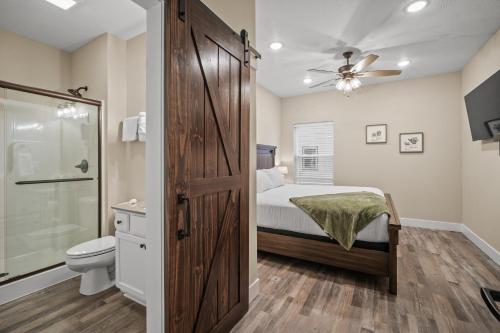 a bedroom with a bed and a sliding barn door at On the Rocks Lodge in Branson