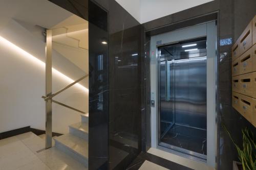 a walk in shower in a room with a glass door at Bergamo SottoSopra Gold in Bergamo