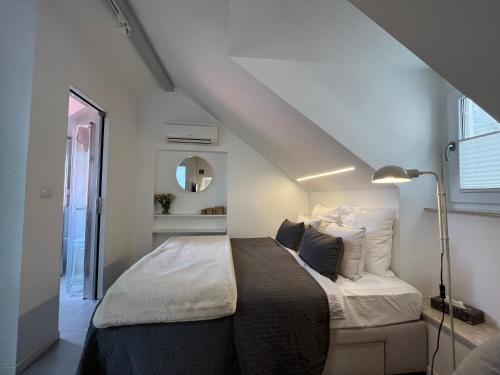 a bedroom with a large bed in a attic at Cozy Old Town Interlude Apartment in Dubrovnik