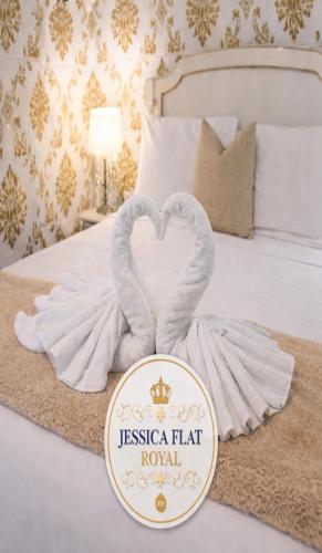 two towels in the shape of two swans on a bed at Jessica Flat Malta Royal Guesthouse in Cospicua