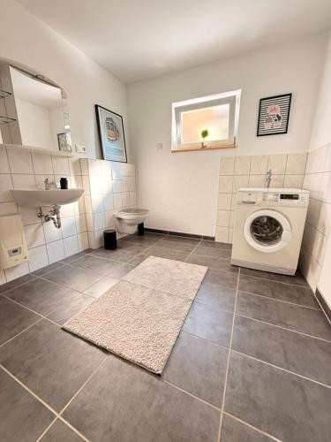 a bathroom with a washing machine and a sink at Auszeit in Bad Sobernheim