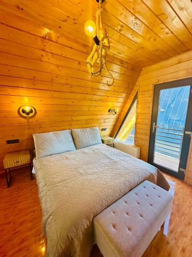 a bedroom with a bed in a wooden room at Twin Cabins Azuga in Azuga