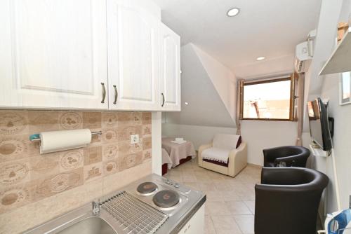 a small kitchen with a sink and a stove at Old town central in Kotor