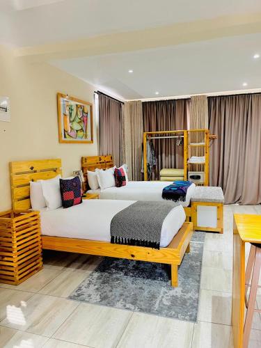 a hotel room with two beds in a room at Thabeng Hotel & Restaurant in Maseru