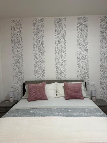 a bedroom with a large bed with red pillows at Via Veneto in Loreto Aprutino