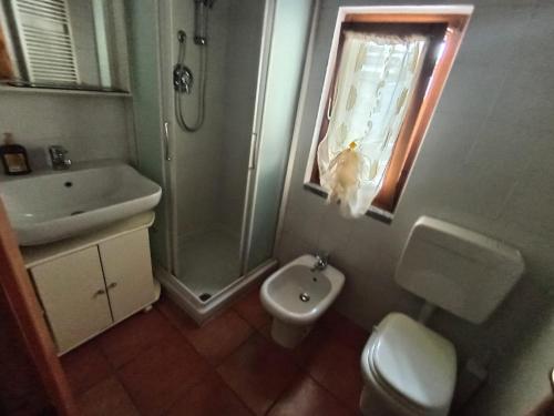 a bathroom with a sink and a toilet and a shower at Holiday home Désirée in Sorico