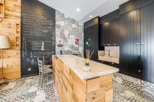 a kitchen with a counter and a chalkboard at Villas de Cintra in Sintra