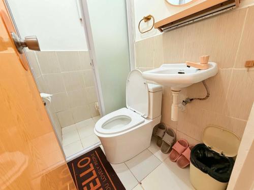 a small bathroom with a toilet and a sink at Olango Island-Tiny Guest House Fully Furnished with Hot Shower, Washer, Wi-Fi, Netflix & King Bed S&E-3 in Lapu Lapu City