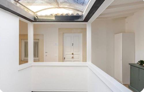 an empty room with a skylight on the ceiling at xenia apartments & suite in Syracuse
