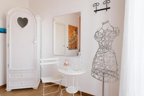 a dress hanging on a wall next to a dressing table at Bergamo Sottosopra in Bergamo