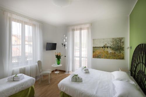a bedroom with two beds and a painting on the wall at Bergamo Sottosopra in Bergamo
