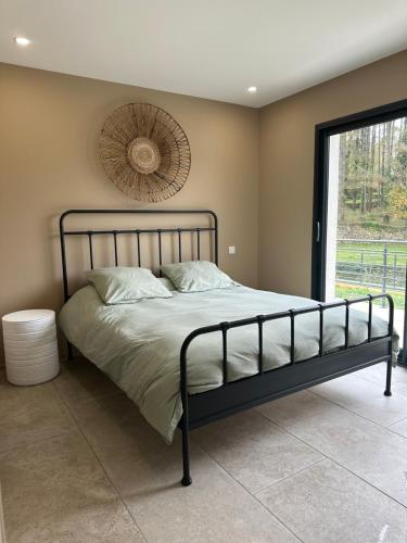 a bedroom with a bed with a fan on the wall at Villa les pins in Chambonas