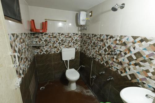 a bathroom with a toilet and a sink at Sri Kalki Jamjam Resort in Erode