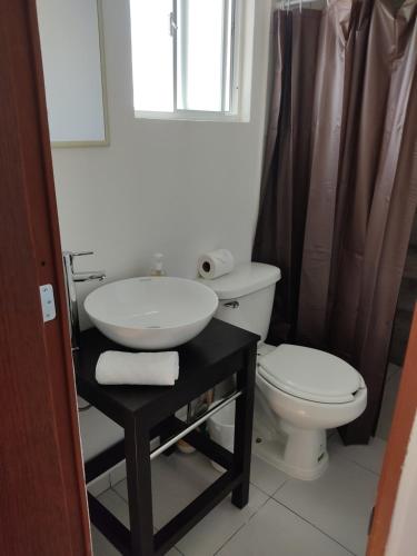 a bathroom with a sink and a toilet at Suites Casa Blanca Metepec in Toluca