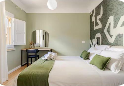 a large white bed in a room with a desk at xenia apartments & suite in Syracuse