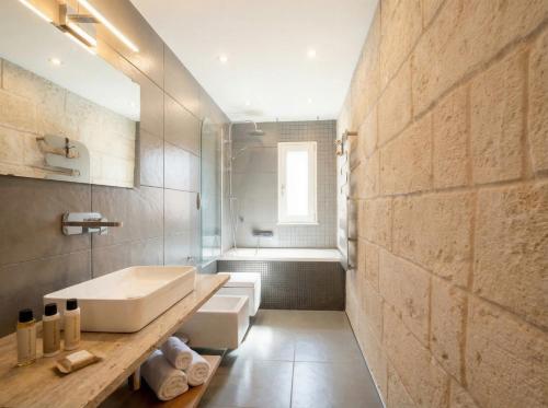 a bathroom with a sink and a bath tub at Terrazza San Martino Private Terrace Stay in Monopoli