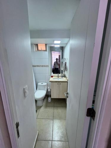 a bathroom with a toilet and a sink and a mirror at Mar & Costa Valparaíso in Valparaíso