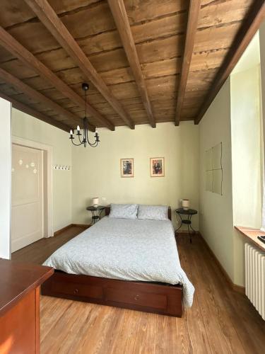 a bedroom with a bed and wooden ceilings at Casa La Torretta in Ceva