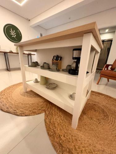 a shelf in a kitchen with a coffee maker at Solua Hostel in Santos
