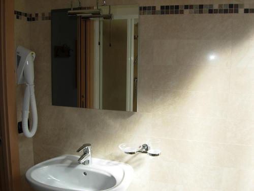 a bathroom with a sink and a mirror at B&B Ledro AFFITTACAMERE in Mezzolago