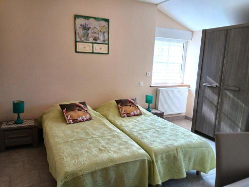 a bedroom with a bed with two pillows on it at Gite Chambres d Hotes des Péguets in Faverolles