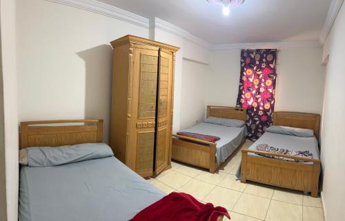 a bedroom with two beds and a dresser in it at Light Tower in Alexandria