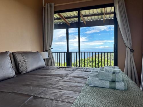 a bedroom with a bed with a large window at Wilderness Escape with breathtaking Views in Wildernis