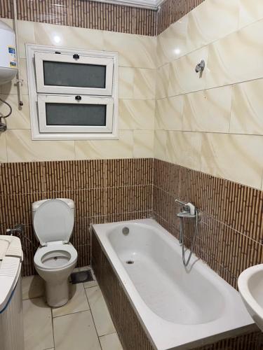 a bathroom with a toilet and a tub and a sink at Light Tower in Alexandria