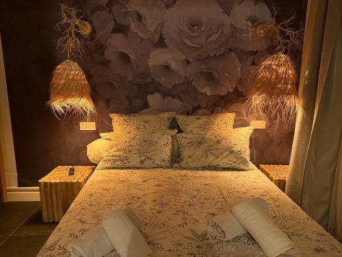 a bedroom with a bed with two lamps on it at LE DUPE in Brissac-Quincé