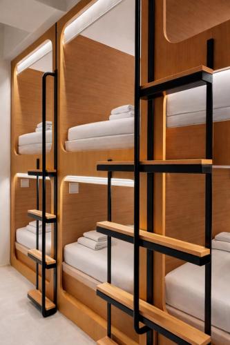 a room with wooden shelving and bunk beds at Wink at Jalan Besar in Singapore