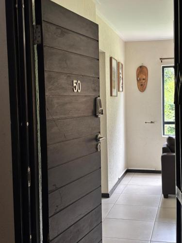 a door in a room with a number on it at Nestled sanctuary in Northriding