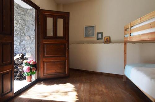 a bedroom with a bed and a door with flowers at Ilia House Altomira in Altomirá