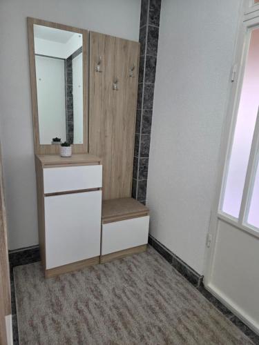 a bathroom with a sink and a mirror at Cosy Apartment in Podgorica - Fast WiFi & cable TV in Konik