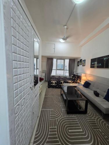 a living room with a couch and a table at Ajman Studio Downtown B2OO7 in Ajman 