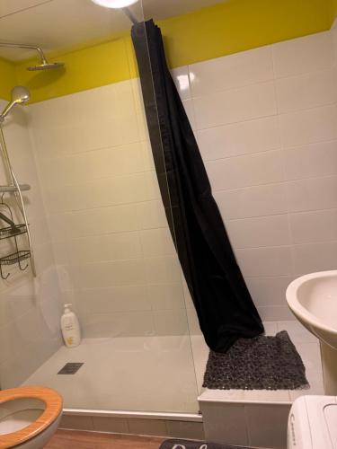 a bathroom with a shower with a black shower curtain at Centre saint malo in Saint Malo
